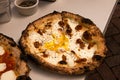 Round gourmet white egg pizza with bacon