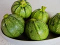 Round green zucchini inside a white plate Royalty Free Stock Photo