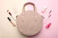 Round handbag and different women`s cosmetics Royalty Free Stock Photo