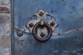 Round handle of an old wrought iron rusty door in a medieval fortress. Royalty Free Stock Photo