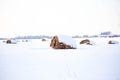 Round hay bales covered with snow on a Wisconsin farmland Royalty Free Stock Photo