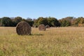 Round hay bales looking like giant wheels in a meadow Royalty Free Stock Photo