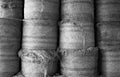 Round hay bales stacked in a barn, black and white. Royalty Free Stock Photo
