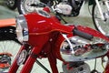 Round headlight and handlebars of red veteran Czechoslovak motorcycle Jawa 350, called Panelka concrete lady, from year 1967