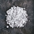 Dry Ice Crystals or Solid Carbon Dioxide on Natural Black Stone Background