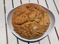 Round home made dark bread in a white plate. Horizontal image