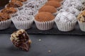 Round homemade chocolates in different kind of decor on paper substrates. Shallow depth of field. Selective focus