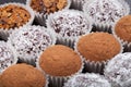 Round homemade chocolates in different kind of decor on paper substrates. Shallow depth of field. Selective focus