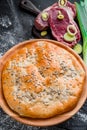 Round homemade meat pie on a black wooden background in a beautiful composition. top view. Space. Close-up Royalty Free Stock Photo