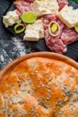 Round homemade meat pie on a black wooden background in a beautiful composition. top view. Space. Close-up Royalty Free Stock Photo