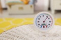 Round hygrometer with thermometer on mat in room. Space for text Royalty Free Stock Photo