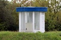 Round industrial water pumping station control room building made of large safety glass windows covered with metal blue roof Royalty Free Stock Photo