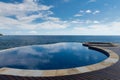 Round infinity pool merge indian ocean view Royalty Free Stock Photo