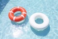 Round inflatables rubber swimming rings in pool. Generative AI Royalty Free Stock Photo