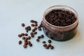 Round jar full of coffee scrub with roasted beans as homemade facial and body exfoliation treatment. Homemade cosmetics for peelin Royalty Free Stock Photo