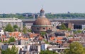 Round Koepelkerk with copper dome next to Singel canal . Roofs and facades of Amsterdam. City view from the bell tower Royalty Free Stock Photo