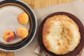 Round lavash traditional pita bread with peaches on ceramic plate