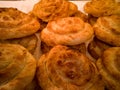 Round layered delicious meat pies close-up