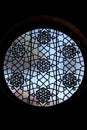 Round leaded glass window with floral medallions and six-point stars