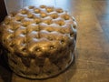 A round leather pouf stands in the lobby of the Rosa Khutor hotel
