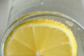 Round lemon slice in slaked soda water Royalty Free Stock Photo