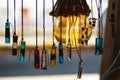 Round light bulb with visible orange glowing filaments and glass made necklaces