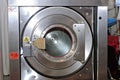 Round loading hatch of the industrial washing machine Royalty Free Stock Photo