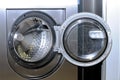 Round loading hatch of the industrial washing machine Royalty Free Stock Photo