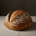 Round loaf of artisan bread with a golden-brown crust, featuring deep, rustic cuts on t Royalty Free Stock Photo