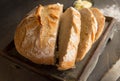 Round loaf of fresh baked crusty bread half sliced Royalty Free Stock Photo