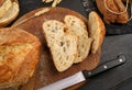 Fresh bread slice and cutting knife on rustic table Concept of homemade bread, natural farm products, domestic