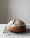Round Loaf of Sourdough Bread on Cooling Rack Royalty Free Stock Photo