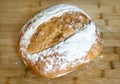 Round loaf of sourdough bread on cutting board