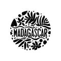 A round logo with a leafy design and the word Madagascar written in a cursive style. The logo