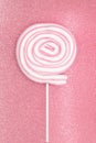 Round marshmallow lollipop on stick on shiny pink background Royalty Free Stock Photo