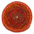 Round mat of brown color crocheted from thick threads. Isolated on a white background