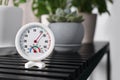 Round mechanical hygrometer on black table indoors. Space for text Royalty Free Stock Photo