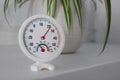 Round mechanical hygrometer on white table indoors. Space for text Royalty Free Stock Photo