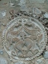 Round medieval stone carving representing birds