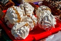 Round meringue cookies filling with condensed milk and nuts on tray