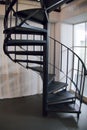 Round metal indoor staircase in a corner