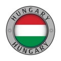 Round metal medallion with the country name Hungary and a round