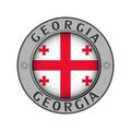 Medallion with the name of the country Georgia and a round flag