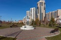 Round metal sculpture on the background of residential buildings, installed in the park of the city of Krasnoyarsk.