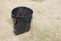 Round Metal trash bag bin structure frame on grass field Royalty Free Stock Photo