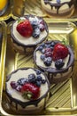 Round mini cake, coffee and vanilla souffle with strawberries, blackberries, raspberries, blueberries Royalty Free Stock Photo