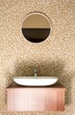 Round mirror with ceramic sink and silver tap