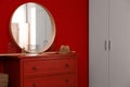 Round mirror and chest of drawers near wall in room. Modern interior design Royalty Free Stock Photo