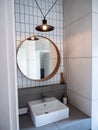 Round mirror decoration in white bathroom