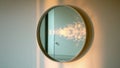 Round mirror reflecting sunlight and interior on white wall Royalty Free Stock Photo